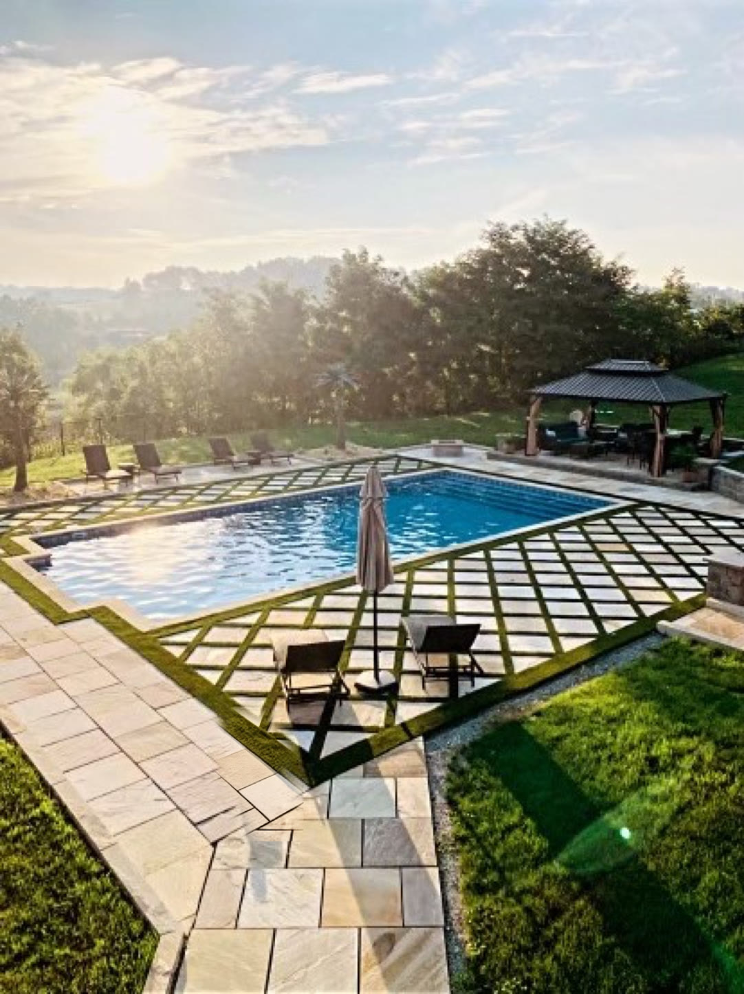 Completed pool surround with a PaverTurf diamond-grid installation