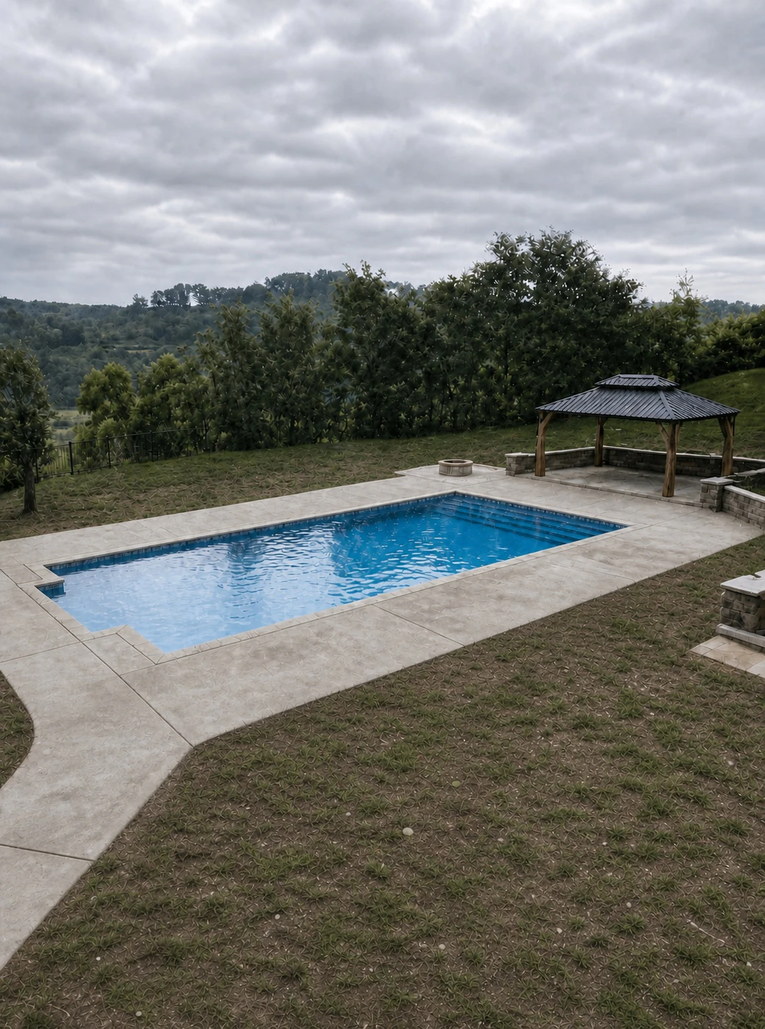Pool surrounded by concrete and naturally worn ground before the illustrative PaverTurf transformation